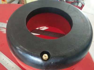 A black and red integral inflatable thread protector is on the ground.