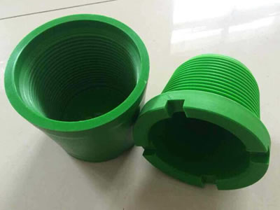 A set of green one-off thread protector is on the ground.