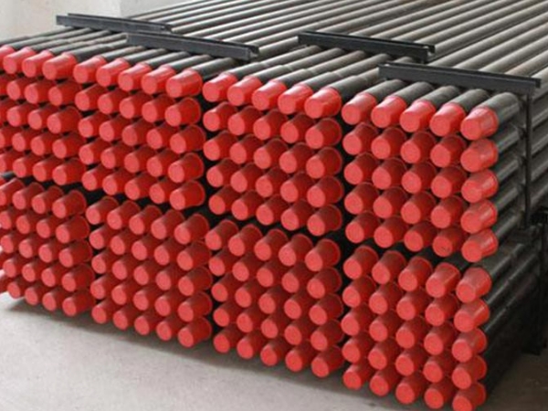 Each drill pipe has a red thread protector on it.