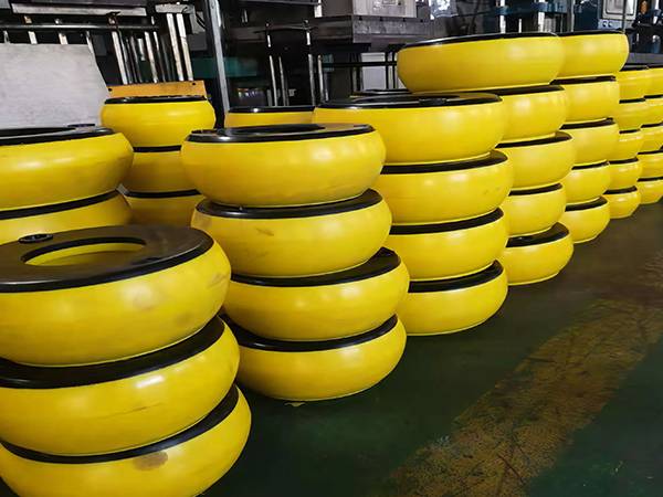 Side view of several piles of yellow integral inflatable thread protectors in factory